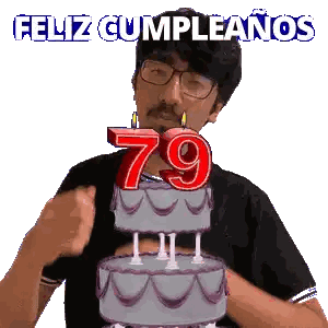 A Man Blowing Out A Candle On A Birthday Cake With The Number 79 On It Sticker