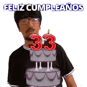 A Man Blowing Out A Candle On A Cake That Says 33 Sticker