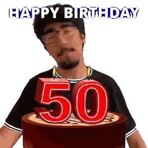 A Man Blows Out A Candle On A Cake That Says 50 Sticker