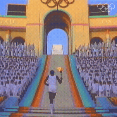 A Man Carrying A Torch In Front Of A Building With The Letters Ios On It GIF