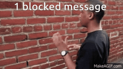 A Man Clapping His Hands In Front Of A Brick Wall With The Words 1 Blocked Message Written Above Him GIF