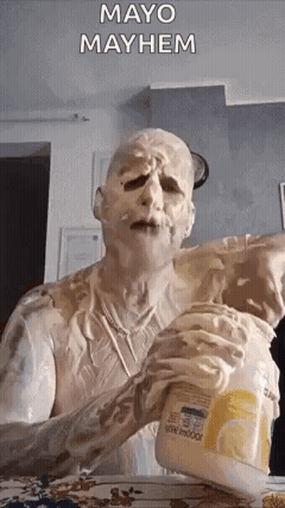 A Man Covered In Mayonnaise Is Holding A Jar Of Mayonnaise . GIF