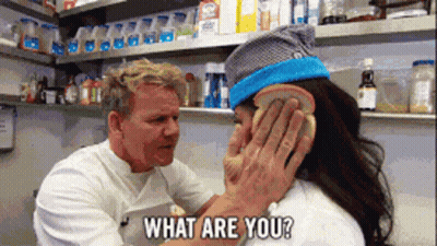 A Man Covering A Woman 'S Ear With A Piece Of Bread And The Words What Are You Behind Him GIF
