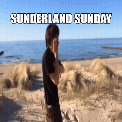 A Man Covering His Face On A Beach With The Words Sunderland Sunday Written Above Him GIF
