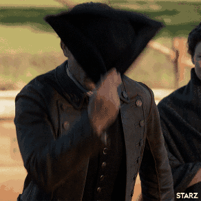 A Man Covering His Face With A Black Hat With Starz Written On The Bottom Left GIF