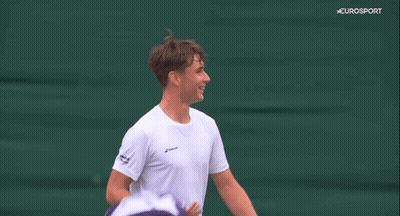 A Man Covering His Face With A Towel While Holding A Tennis Racquet On A Eurosport Screen GIF
