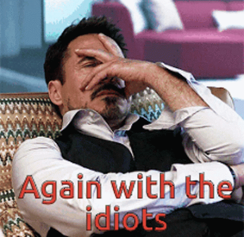 A Man Covering His Face With His Hand And The Words Again With The Idiots GIF