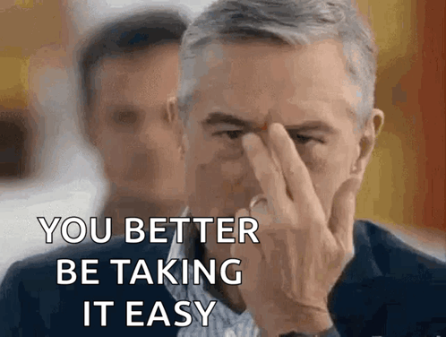 A Man Covering His Face With His Hand And The Words " You Better Be Taking It Easy " GIF