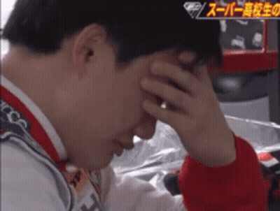 A Man Covering His Face With His Hand In A Video With Chinese Writing On It GIF