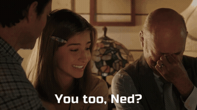 A Man Covering His Face With His Hand While A Woman Smiles And The Words You Too Ned Are Displayed GIF