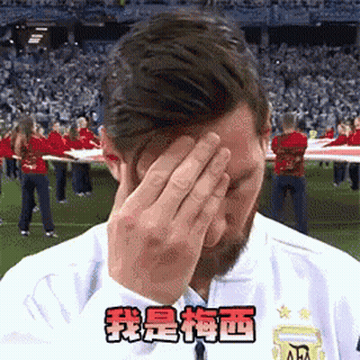 A Man Covering His Face With His Hands In Front Of A Crowd Of People . GIF
