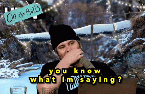 A Man Covering His Mouth With His Hand And A Sign That Says " Off The Rails " Behind Him GIF