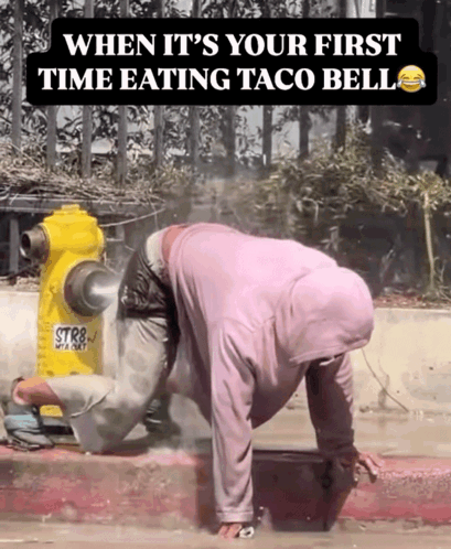 A Man Crawling On The Sidewalk Next To A Yellow Fire Hydrant That Says Str8 GIF