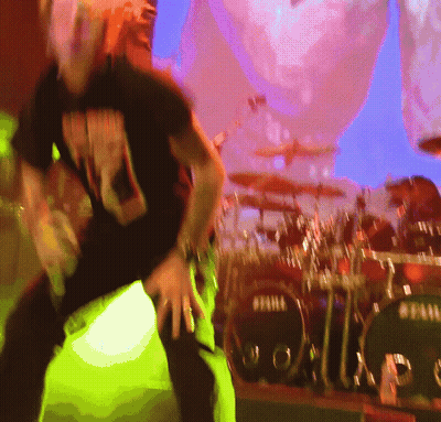 A Man Dancing In Front Of A Drum Set That Says Tama GIF