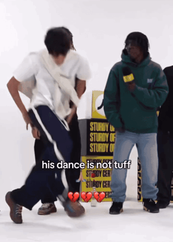A Man Dancing In Front Of A Yellow Sign That Says Sturdy GIF