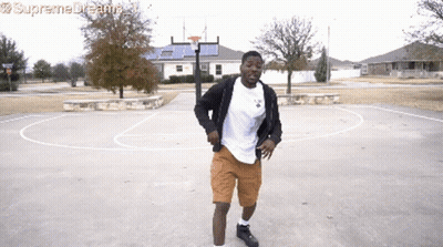 A Man Dancing On A Basketball Court With Supreme Dreams Written On The Bottom Right GIF