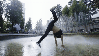 A Man Does A Handstand In A Fountain GIF