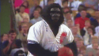 A Man Dressed As A Gorilla Holding A Basketball GIF