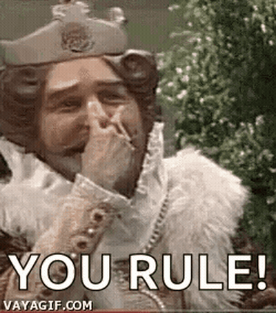 A Man Dressed As A King Is Covering His Mouth With His Hand And Smoking A Cigarette . GIF