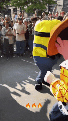 A Man Dressed As A Minion Stands In Front Of A Crowd GIF