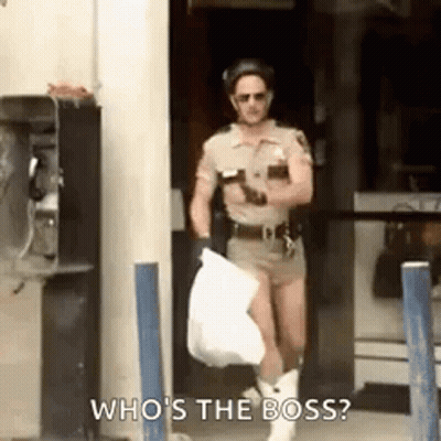 A Man Dressed As A Police Officer Is Carrying A Bag And Asking Who 'S The Boss . GIF