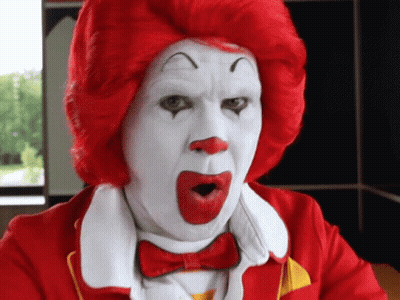 A Man Dressed As Mcdonald 'S Ronald Mcdonald With A Surprised Look On His Face GIF