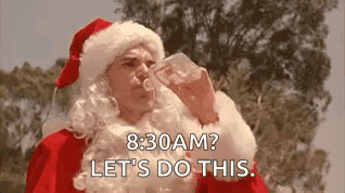 A Man Dressed As Santa Claus Is Drinking From A Bottle . GIF