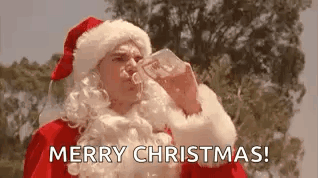 A Man Dressed As Santa Claus Is Drinking Water From A Bottle And Saying Merry Christmas . GIF
