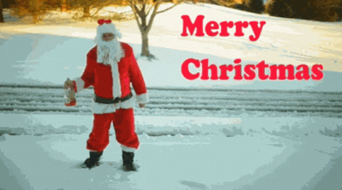 A Man Dressed As Santa Claus Is Standing In The Snow With Merry Christmas Written In Red Letters GIF