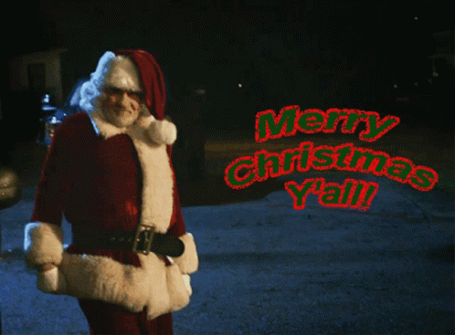 A Man Dressed As Santa Claus Says Merry Christmas Y'all In Red Letters GIF