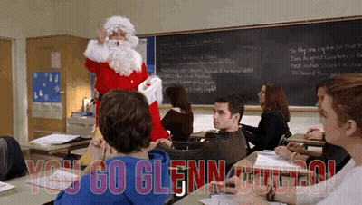 A Man Dressed As Santa Claus Stands In Front Of A Classroom With The Words You Go Glenn GIF