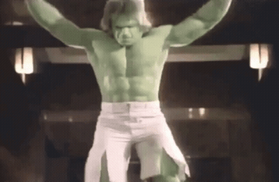 A Man Dressed As The Hulk Is Standing On A Cross With His Arms Outstretched GIF