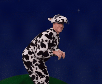 A Man Dressed In A Cow Costume And Hat GIF