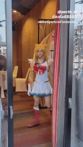 A Man Dressed In A Sailor Moon Costume Stands In A Doorway GIF