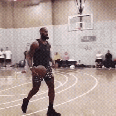 A Man Dribbles A Basketball On A Court With The Word Nike On His Shorts GIF