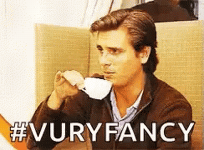 A Man Drinking A Cup Of Coffee With The Words #Vuryfancy Written Below Him GIF