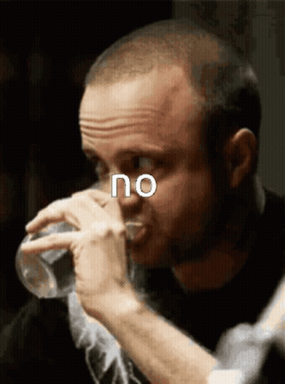 A Man Drinking A Glass Of Water With The Word No Above His Face GIF