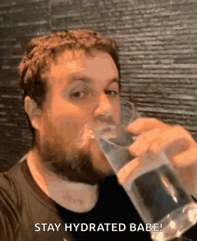 A Man Drinking A Glass Of Water With The Words Stay Hydrated Babe GIF