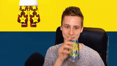 A Man Drinking From A Can With A Pair Of Shorts With Stars On Them In The Background GIF