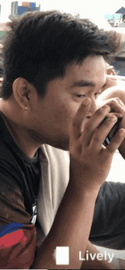 A Man Drinking From A Cup With The Word Lively On The Bottom Left GIF