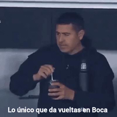 A Man Drinking From A Cup With The Words Lo Unico Que Da Vueltas En Boca Written Below Him GIF