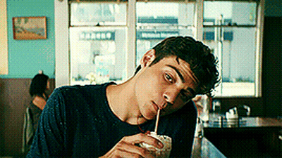 A Man Drinking Through A Straw In A Diner GIF