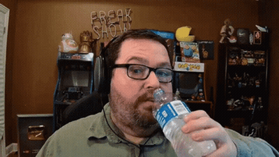 A Man Drinking Water From A Bottle With A Break Show Sign In The Background GIF