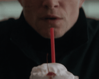 A Man Drinks A Milkshake With A Cherry On Top GIF