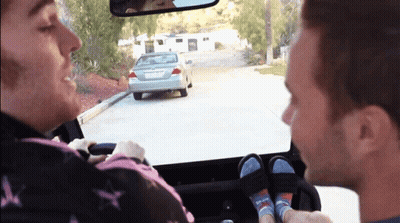 A Man Driving A Car With A License Plate That Says ' Lgc ' On It GIF
