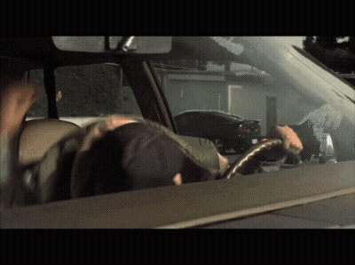 A Man Driving A Car With A Sticker On The Windshield That Says ' A ' On It GIF