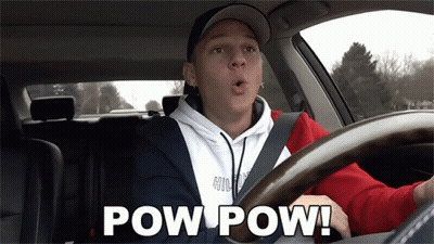 A Man Driving A Car With The Words Pow Pow Written On The Screen GIF