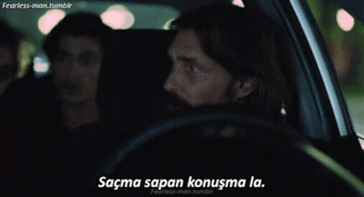 A Man Driving A Car With The Words " Sacma Sapan Konuşma La " On The Bottom Right GIF