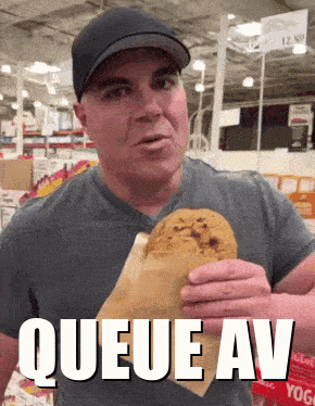 A Man Eating A Cookie With The Words Queue Av Written Above Him GIF