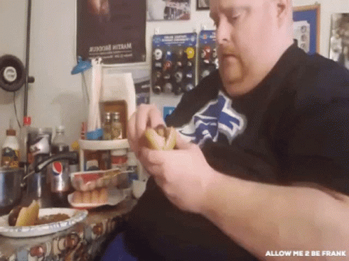 A Man Eating A Hot Dog With The Words Allow Me 2 Be Frank Written On The Bottom GIF